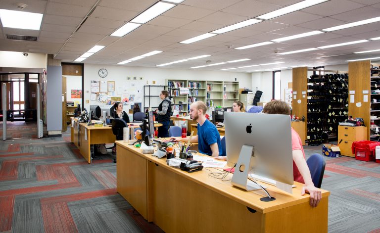 Merit library staff working at their computers