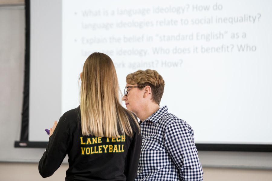 Professor Lesley Bartlett looking over student's work in class.