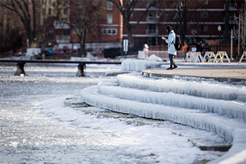 Person standing in front of frozen steps at Memorial Union during the winter.