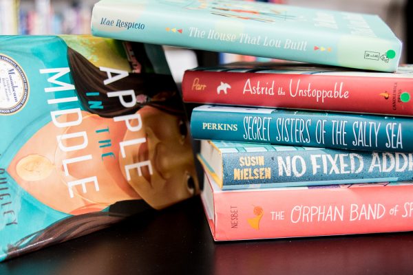 Pile of red and blue books resting upon each other.