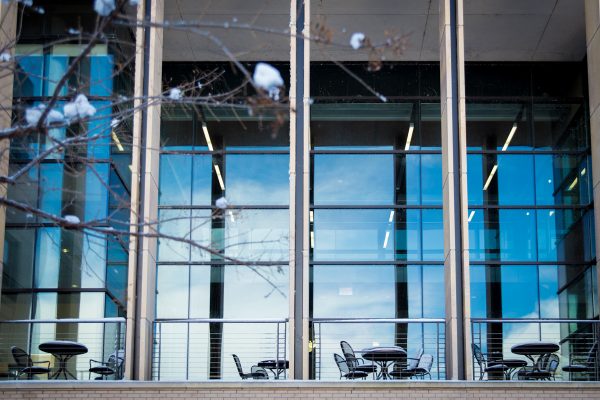 Back of the Education building with outside seating and tall windows