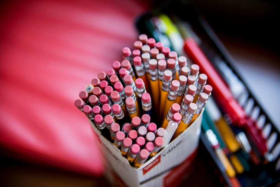 A close up of #2 pencils with the erasers facing up in a box.