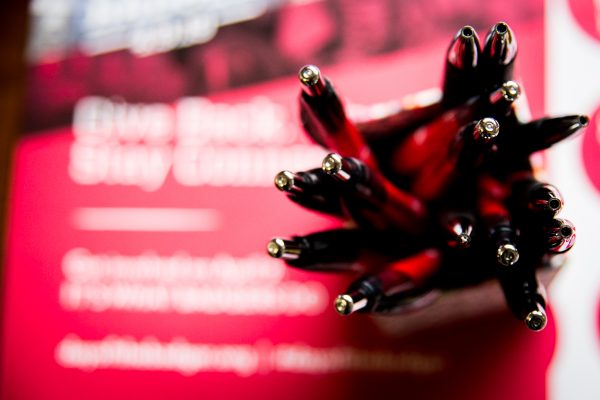 group of red and black pens on a red background