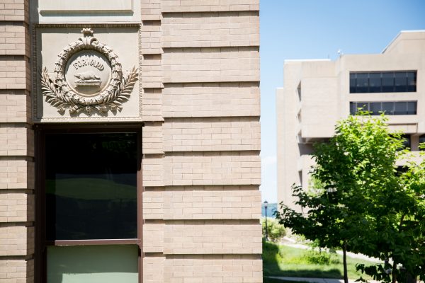 Forward emblum on the front of the uw school of education building.