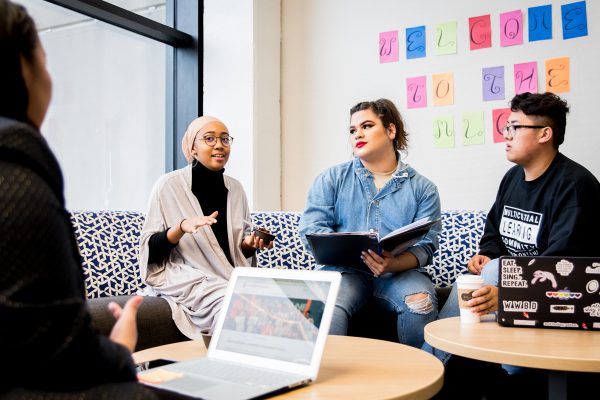 three students meet with their advisor