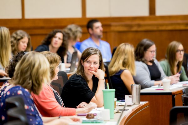 Conference participants network with one another.