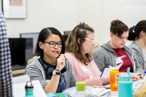 students sitting at a table learning